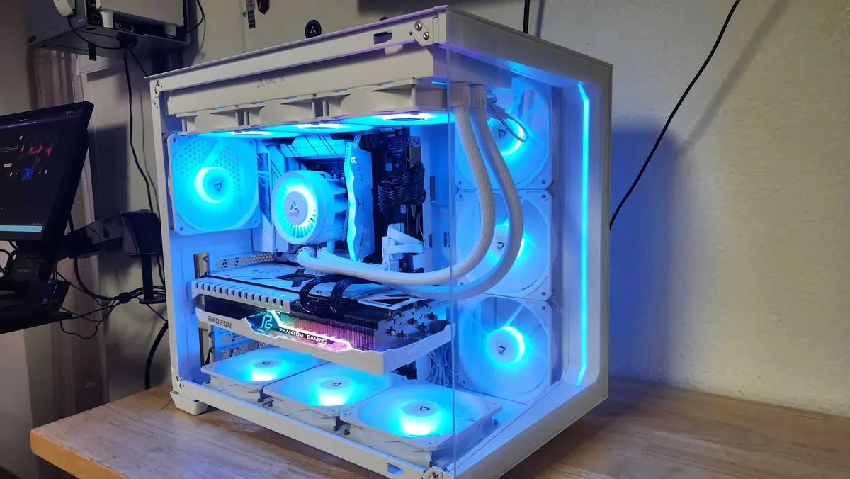 White custom gaming PC with coordinated blue lighting and liquid cooling